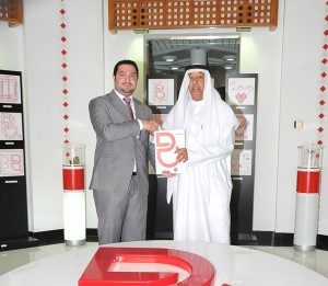 Batelco Public Relations Manager Osama Alsaad presents the sponsorship cheque to Rashid Equestrian Club PR Manager Hamad Al Noaimi